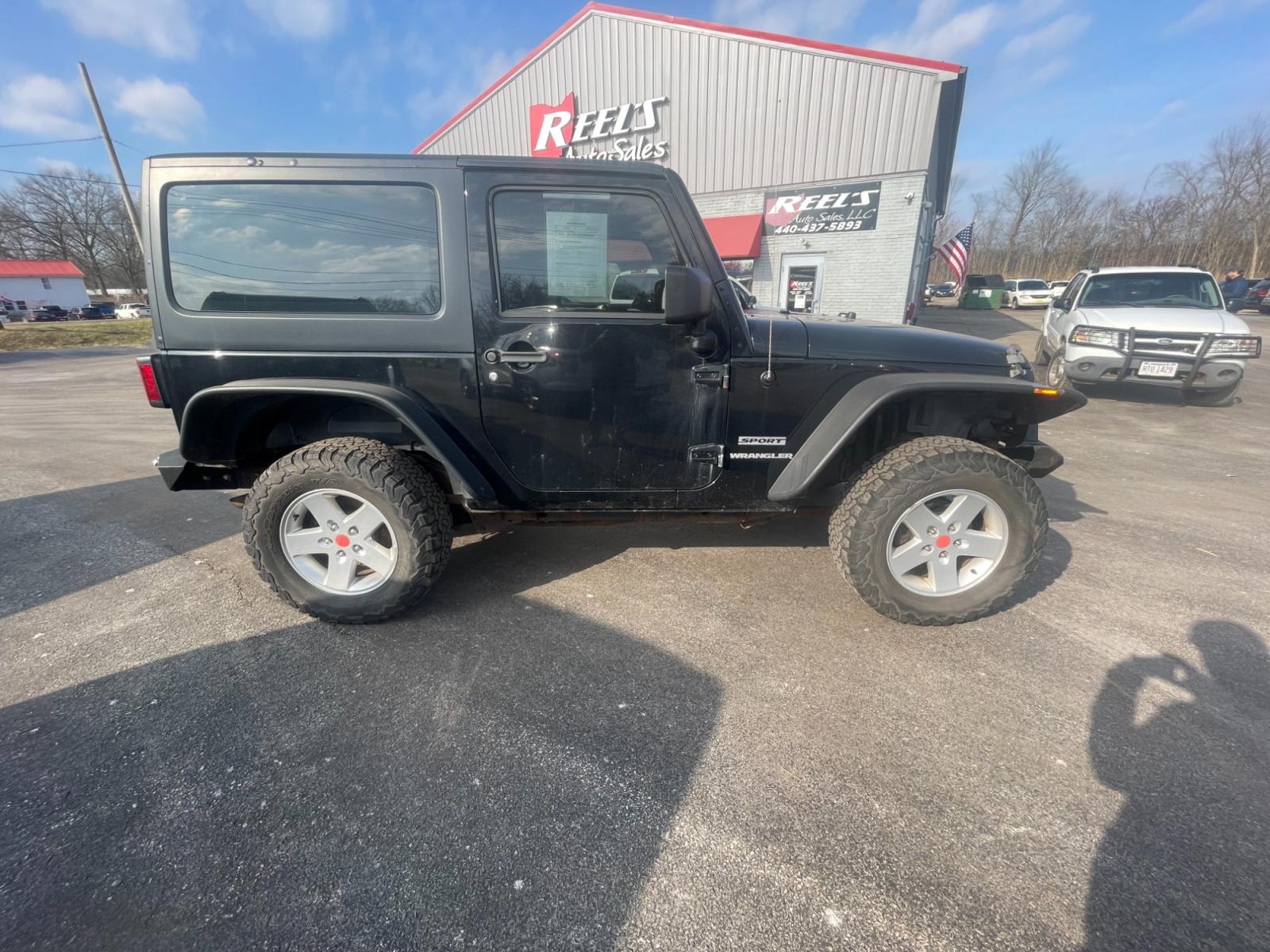 2013 Black /Black Jeep Wrangler Sport 4WD (1C4AJWAG0DL) with an 3.6L V6 DOHC 24V FFV engine, 6 Speed Manual transmission, located at 547 E. Main St., Orwell, OH, 44076, (440) 437-5893, 41.535435, -80.847855 - This 2013 Jeep Wrangler Sport 4WD, equipped with a robust 3.6L Pentastar V6 engine and a 6-speed manual transmission, represents a premium blend of performance and rugged capability. Its Trail Rated designation underscores a commitment to off-road excellence, featuring modifications such as LED head - Photo #6